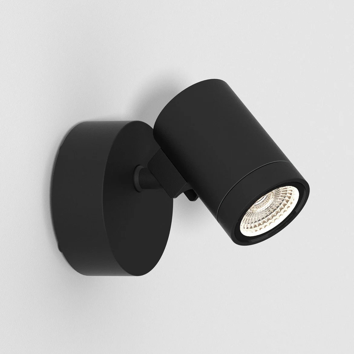 The Bayville spot light features a sleek, modern design with cylindrical body and round base for installation on a wall or surface. Made from steel in a textured black finish with a single spotlight. IP65 rated and suitable for outdoor use. Complete with an integrated 8.1W LED in 3000K.