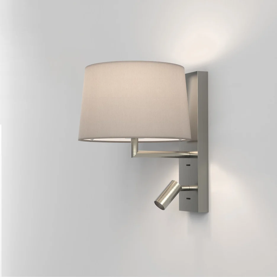 The Telegraph wall light features a sleek, modern design with an angled arm and rectangular backplate in a matt nickel finish. Available with a tapered shade in four colours: white, black, putty, and mocha. Shows the version with a reading lamp.