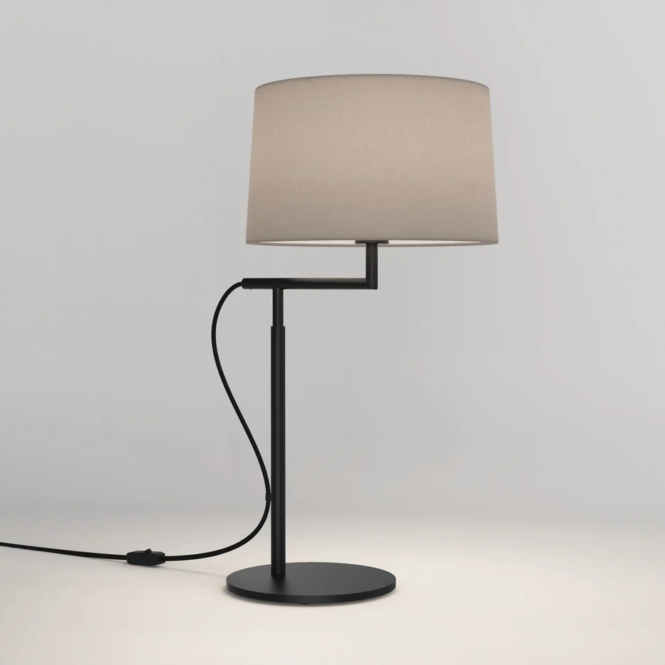 The Telegraph table light features a sleek, modern design with an angled arm and round base in a matt black finish. Available with a tapered shade in four colours: white, black, putty, and mocha.