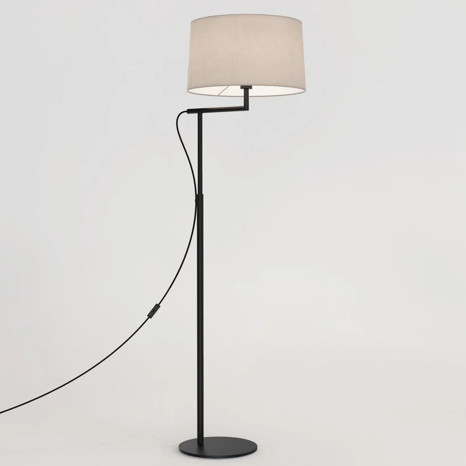 The Telegraph floor light features a sleek, modern design with an angled arm and round base in a matt black finish. Available with a tapered shade in four colours: white, black, putty, and mocha.