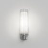 The Ottavino wall light features a modern cylindrical design with ribbed glass and a polished chrome lampholder. Shows a frontal view of the unit. IP44 rated and safe for use in bathrooms.