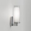 The Ottavino wall light features a modern cylindrical design with ribbed glass and a polished chrome lampholder. Shows a side view of the unit. IP44 rated and safe for use in bathrooms.