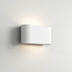 The Velo wall light is a modern, oval shaped uplight/downlight in a white plaster finish which can be painted to any desired colour.