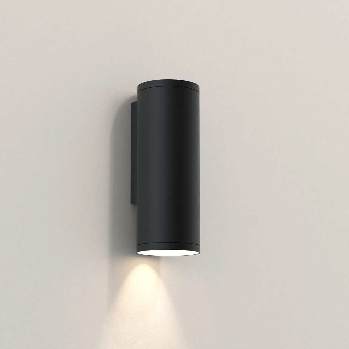 The Ava wall light is a modern style downlight with a simple cylindrical design and sleek textured black finish. IP44 rated and suitable for outdoor use.