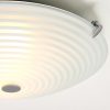 Shows a close up of the Roundel ceiling light, which features a round opal glass shade with a decorative swirling pattern and chrome plate detailing. Shows the fitting when switched on.