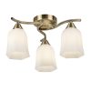 The Alonso ceiling light features an elegant design with 3 curved arms complete with hexagonal opal glass shades in an antique brass finish.
