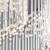 Close up of the Camille pendant light's clear glass rods. The pendant is a stunning chandelier with 24 lamps, featuring a mix of glass rods and faceted glass beads. Multiple rings support the delicate glass detailing in a sleek chrome finish.