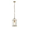 The Lambeth pendant light features a steel framework in an antique brass finish, with clear glass enclosing the lamp.