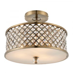 The Hudson ceiling light features clear crystal beads inset into an antique brass shade with an opal diffuser fitted at the bottom.