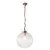 The Brydon pendant light features a clear ribbed glass globe suspended by antique brass chain suspension. This fitting is ⌀35cm in diameter.