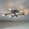 The Pipe ceiling light features an industrial design with a 6-light crossbar in an aged pewter finish with exposed LED lamps at each end. Shows the fitting turned on.