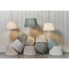 The Freya lampshade features a contemporary, tapered design with pleated fabric. Shows the many beautiful colours to choose from such as charcoal, silver, dusty pink, oyster, teal, and ivory. Available in a ø12 and ø14 inch sizes.