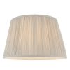 The Freya lampshade features gathered pleated silk in silver with a matching taped edge, pale ivory inner lining, and a reversible gimbal allowing the shade to be used as a table or pendant light.