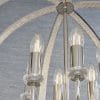 Close up of the Ritz pendant light which features a highly polished bright nickel metalwork, encrusted with thousands of clear faceted reflective details. The spherical cage encloses 6 lamps. Shows the pendant against a grey backdrop.