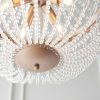 Close up of the bottom of the Celine pendant light and its rose gold effect finished metalwork base and clear glass bead detailing.