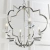Shows a close up of the Garland pendant light hanging in a white room. The pendant light features a decorative eight arm metalwork frame in a polished nickel finish with four premium crystal glass lamp holders.