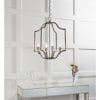 Shows the Lainey pendant light hanging over a table in a white room. The pendant features a decorative five arm metalwork frame in an antique brass with four premium crystal glass lamp holders.