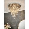 Shows the Melody ceiling light in a room, showing the lighting effect. Features a tiered design with hanging crystal glass beads and teardrops alongside chrome, leaf shaped details enclosing 6 lamps.