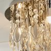 Close up of the top of the Melody ceiling light and the hanging crystal glass beads and teardrops alongside chrome, leaf shaped details enclosing 3 lamps. The recessed base is also finished in chrome.