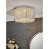Shows the Galina ceiling light in an elegant room. Features a shade of delicate twisted chrome rods enclosing high quality K9 clear hanging crystals.