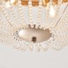Close up of the Celine ceiling light's base in rose gold effect finish with clear glass draped bead detailing attached.
