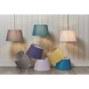 The Evie lampshade features a contemporary, tapered design. Shows the many beautiful colours to choose from such as gold, teal, pink, violet, charcoal, and light grey. Available in a ø14 inch size.