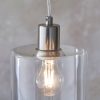 Close up of the top of the Toledo pendant light, showing the lampholder with a brushed nickel finish and the detail of the cylindrical clear glass shade.