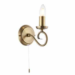 The Trafford wall light has an elegantly curved arm in an antique brass finish with traditional lampholder and pull cord switch.