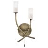 The Havana wall light features a modern design in an antique brass finish, complete with glass shades. The two arms are curved over one another in a decorative twist.
