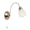 The Petal wall light features an arching arm in an antique brass finish, complete with frosted glass flower shaped shade.
