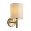 The Brio wall light features a modern design in an antique brass finish complemented by an off-white faux silk shade.