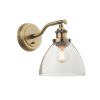 The Hansen wall light is an industrial style light in antique brass with ridged lampholder and clear glass shade.