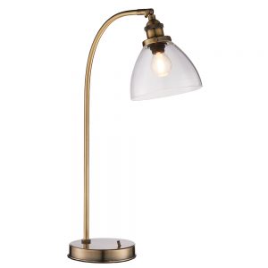 The Hansen table light is an industrial style light in antique brass with ridged lampholder and clear glass shade.