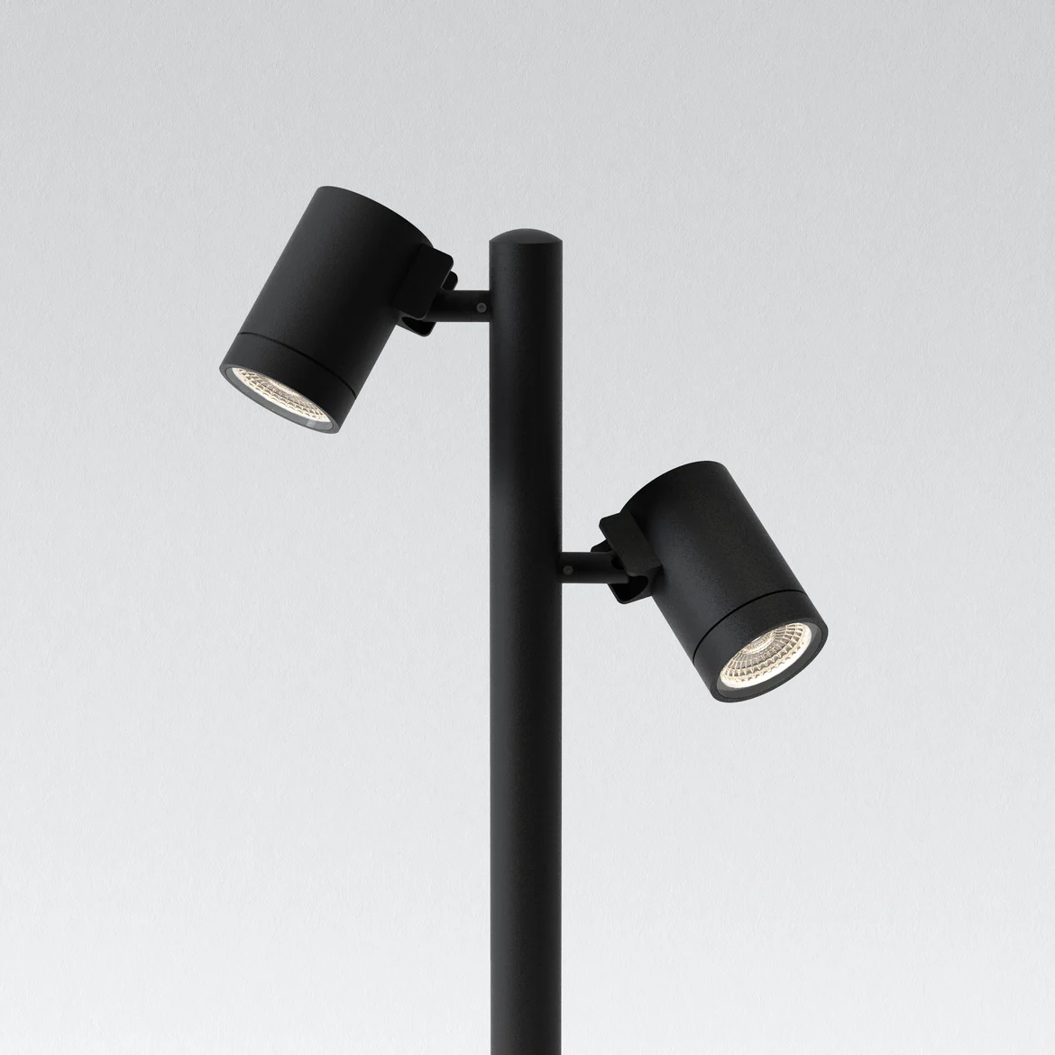 The Bayville Spike 900 spot light features a sleek, modern design with cylindrical body ending in a spike for outdoor in-ground installation with two mounted spotlights. Made from steel and available in a textured black finish. IP66 rated and suitable for outdoor use. Comes complete with an integrated 15.7W LED in 3000K.