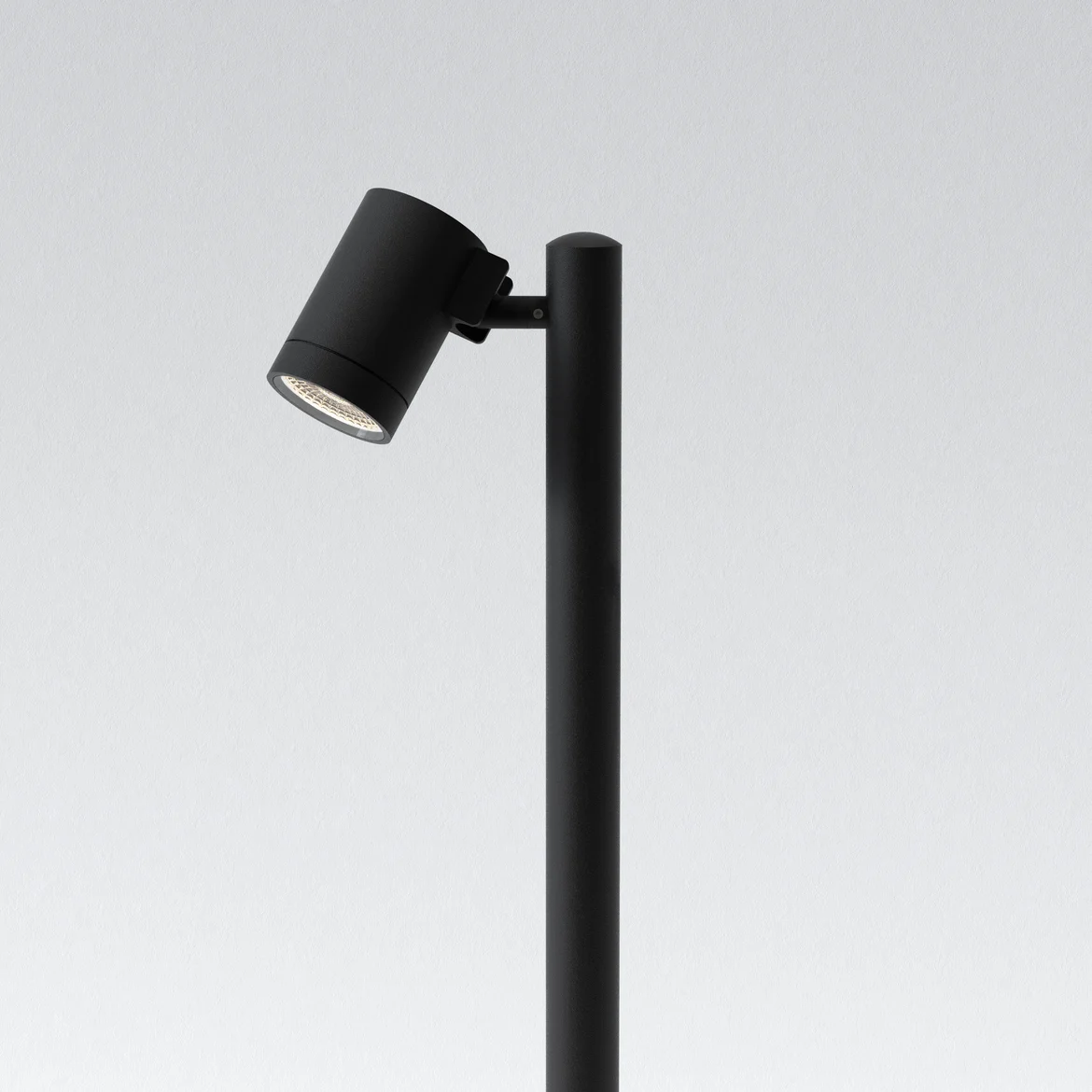 The Bayville Spike 900 spot light features a sleek, modern design with cylindrical body ending in a spike for outdoor in-ground installation with a mounted spotlight. Made from steel and available in a textured black finish. IP66 rated and suitable for outdoor use. Comes complete with an integrated 8.1W LED in 3000K.
