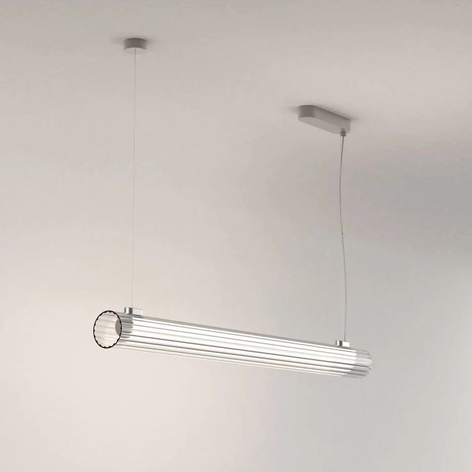 The io pendant light features a modern cylindrical design with ribbed glass and detailing in a polished chrome finish.