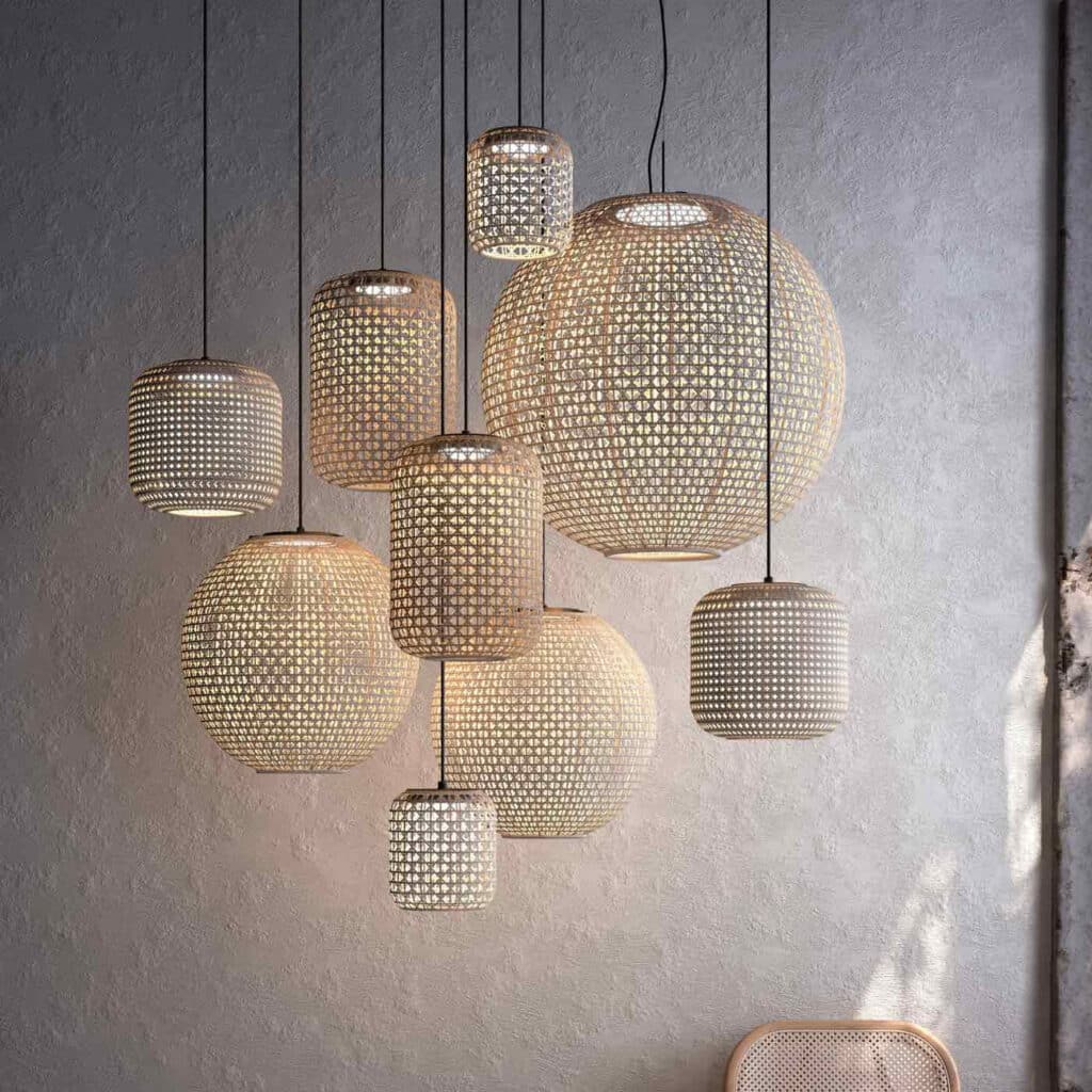 Bover Lighting - An array of pendant lamps from the collection in front of a wall