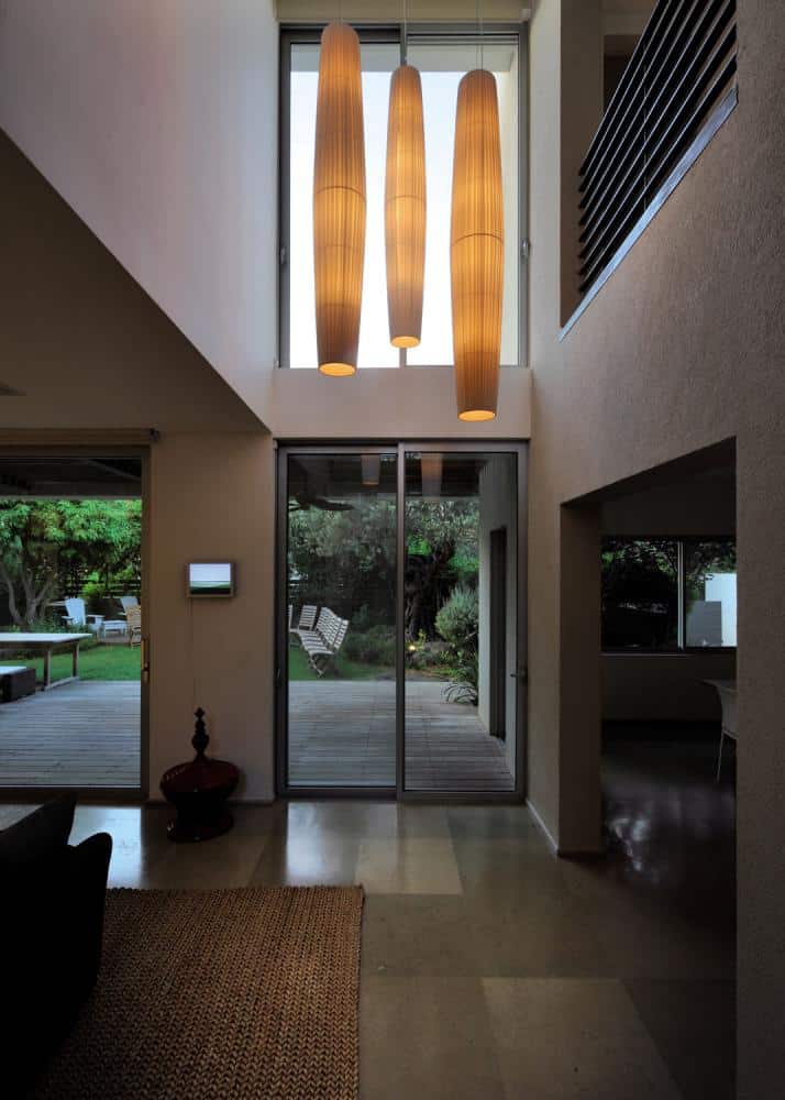 Bover Lighting - A selection of three Indoor Maxi Pendants hanging from a ceiling in front of a doorway