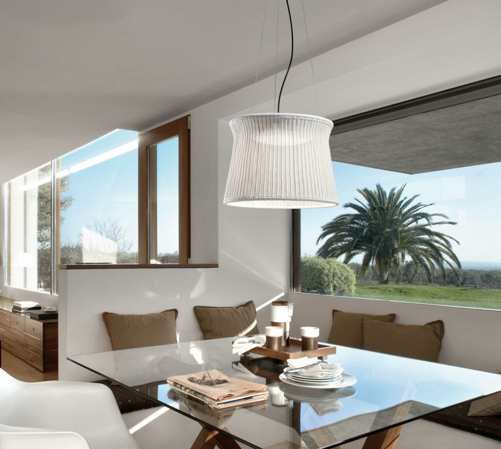 Bover Lighting - A singular Syra pendant hanging over a dining room table